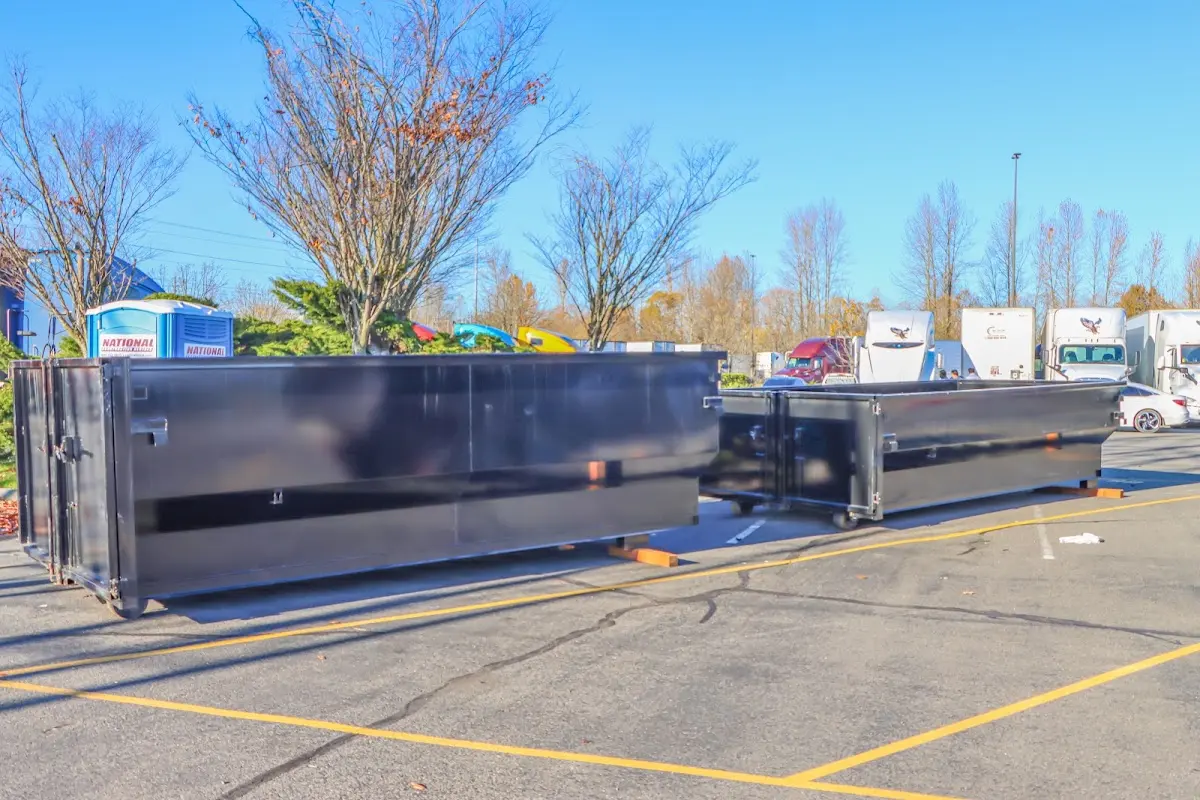 Professional dumpster rental service with roll-off container on residential driveway in Shawnee